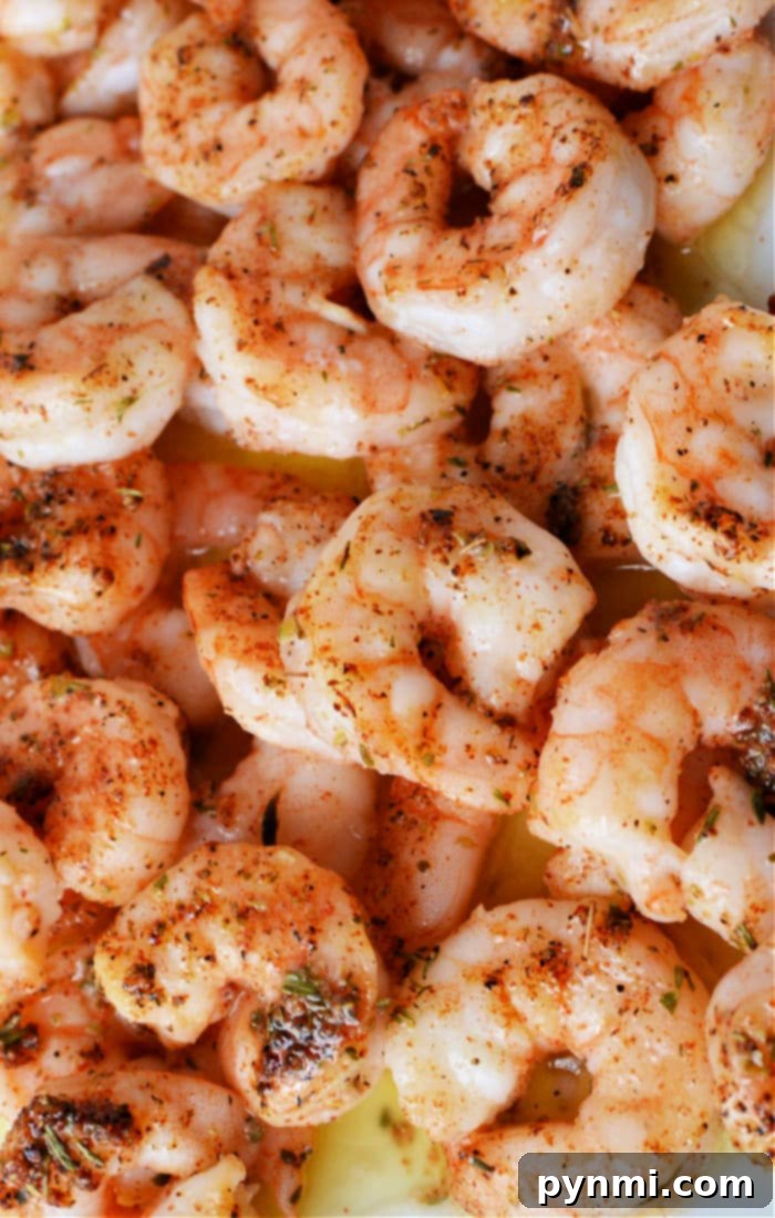 From Freezer to Flavorful Shrimp 2 Discover the vibrant flavors of how to cook frozen raw shrimp, with each tender morsel seasoned perfectly with herbs and spices, captured in this close-up shot.