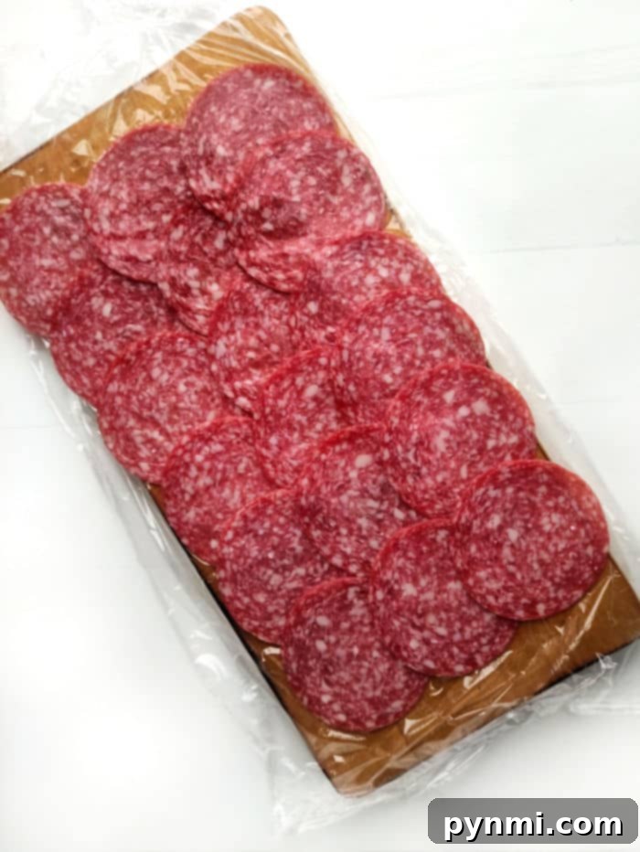 Zesty Salami Pickle Pinwheels 3 Pickle Salami Roll Ups on a Cutting Board