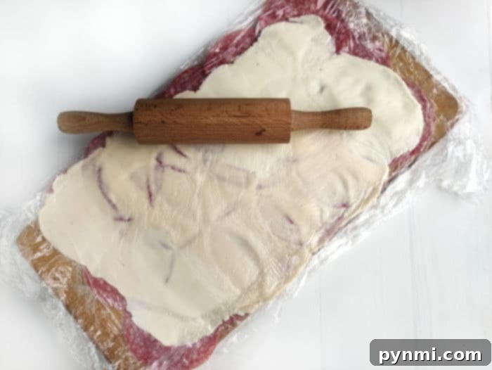 Zesty Salami Pickle Pinwheels 4 Roll Up Appetizers on a Red Plate
