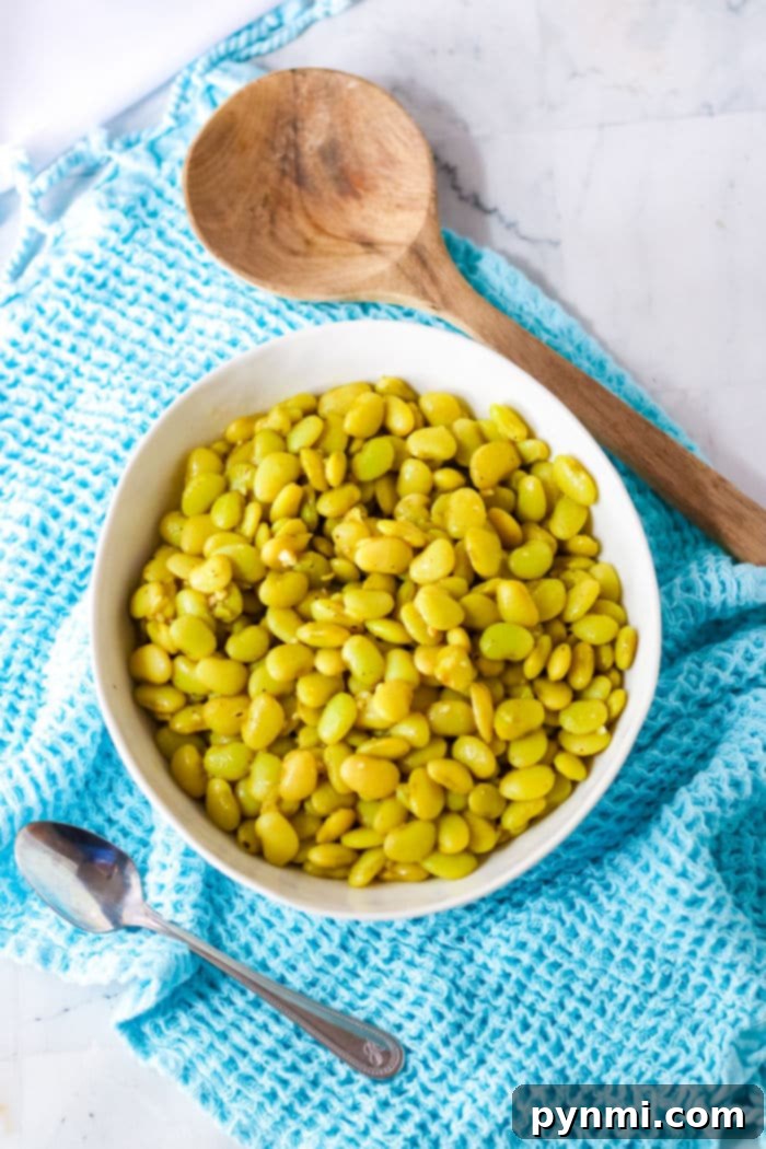 A generous serving of Southern-style lima beans with ham, garnished and ready to be enjoyed as a hearty meal.