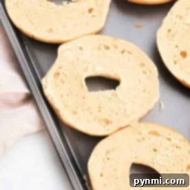 Sliced bagels placed on a baking sheet, showing how to toast a bagel in the oven for perfectly crisp results.