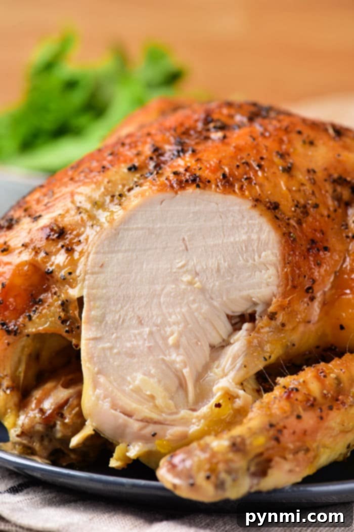 A roasted whole chicken is being served on a cutting board, with various carved pieces visible. Its golden, crispy skin and juicy meat indicate perfect cooking. The image asks, 'How long to cook whole chicken per pound?' emphasizing precise timing.