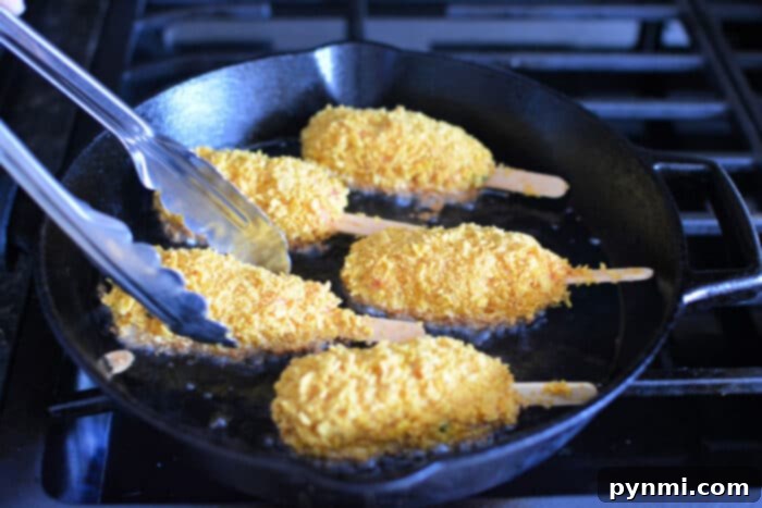 Delicious Homemade Vegan Drumsticks 5 Four mock chicken legs frying in a cast iron skillet