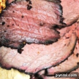 Slices of succulent Sirloin Tip Roast on a wooden cutting board