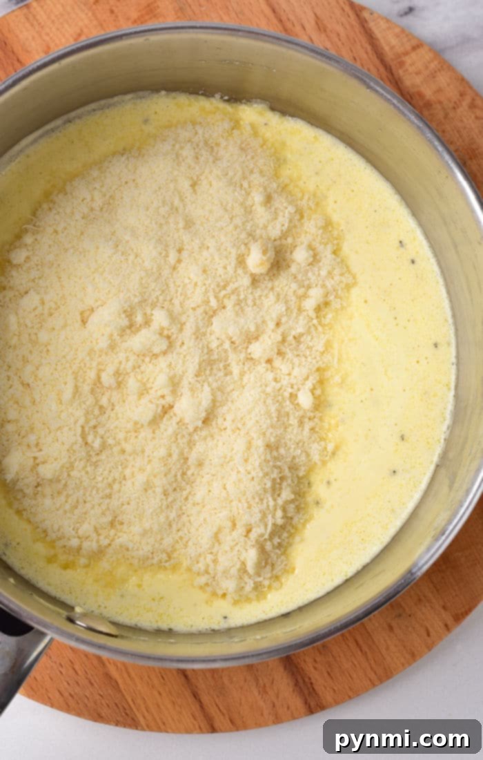A vibrant bowl of Cajun Alfredo Sauce, rich and creamy, garnished with fresh herbs, ready to be served over pasta.