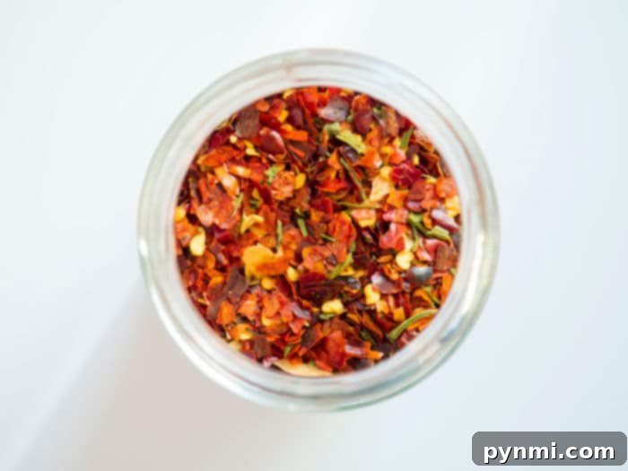 Close-up of vibrant red pepper flakes, ready to add a spicy kick to any dish.