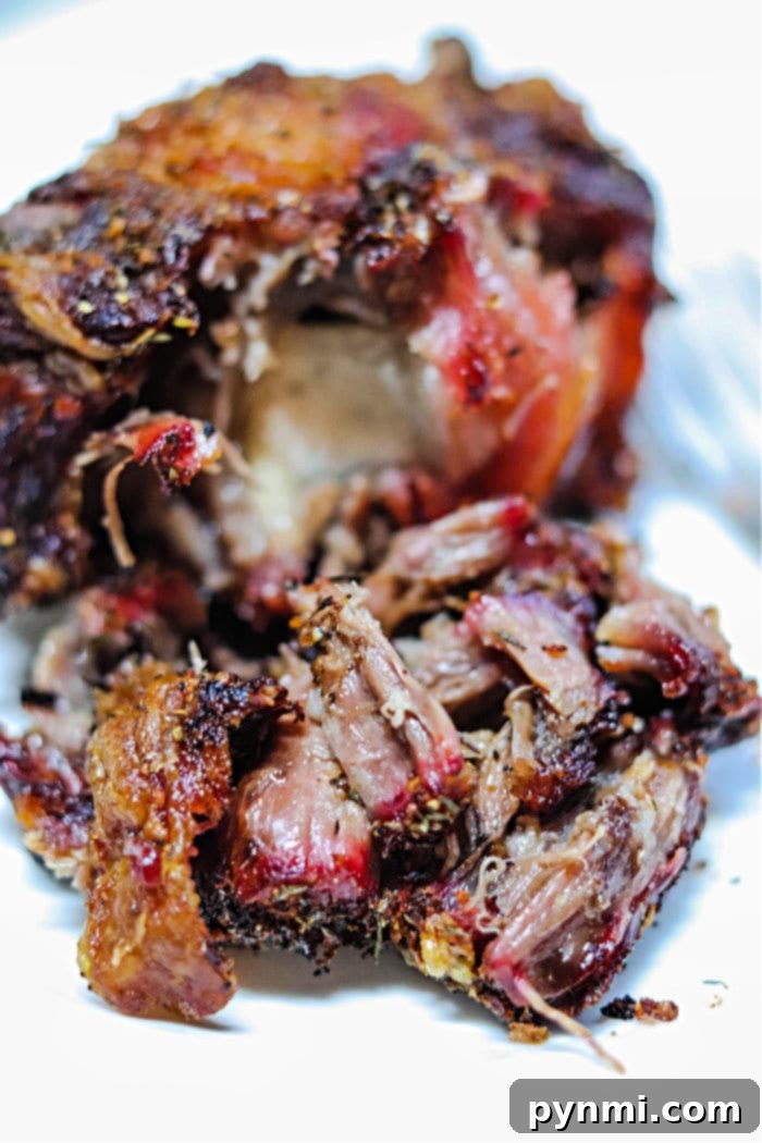 Smoked Oxtail garnished on a cutting board, showcasing its tender texture.