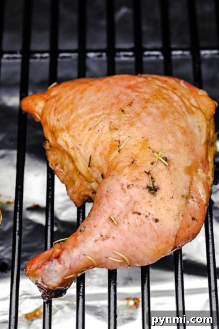 Smoked Chicken Quarters on a Cutting Board with Herbs