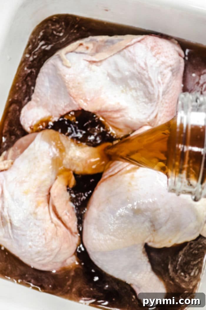 Smoker's Secret Chicken Brine 4 Brined raw chicken pieces are neatly arranged on a grilling rack, ready for the smoker or grill, showcasing their preparation.