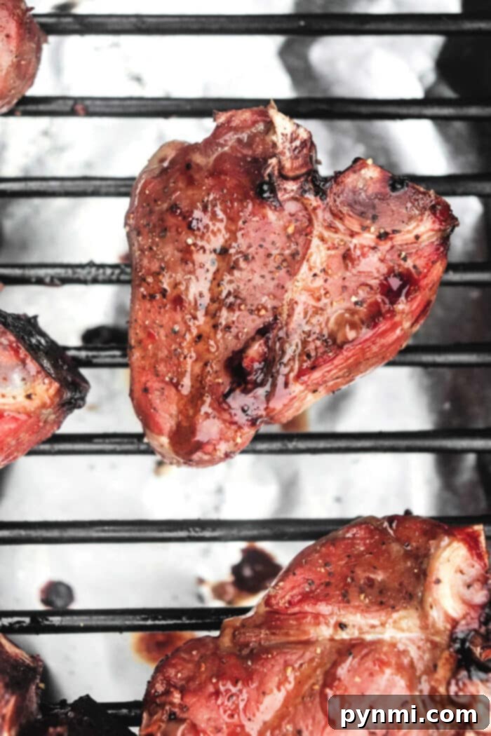 Exquisitely smoked lamb loin chops, perfectly cooked and rested, showcasing a beautiful crust and juicy interior.