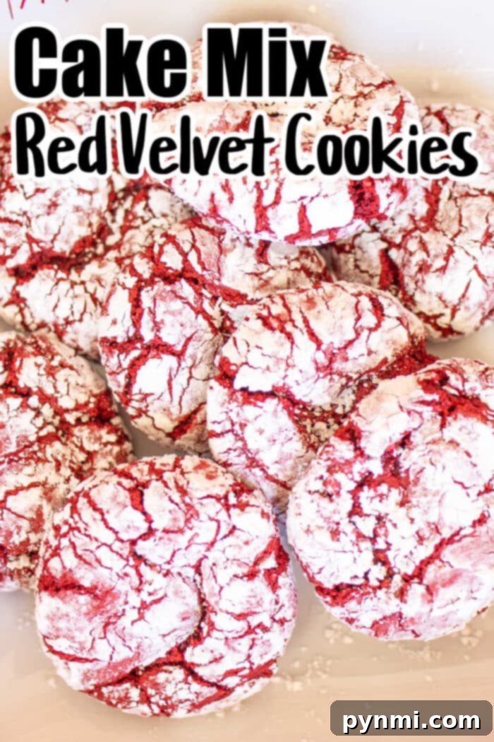 Red Velvet Crinkle Cookies from Cake Mix 5 A pile of Red Velvet Crinkle Cookies coated in powdered sugar is pictured. The text at the top reads "Cake Mix Red Velvet Cookies." The cookies have a cracked appearance, with red velvet showing through the white powdered sugar.