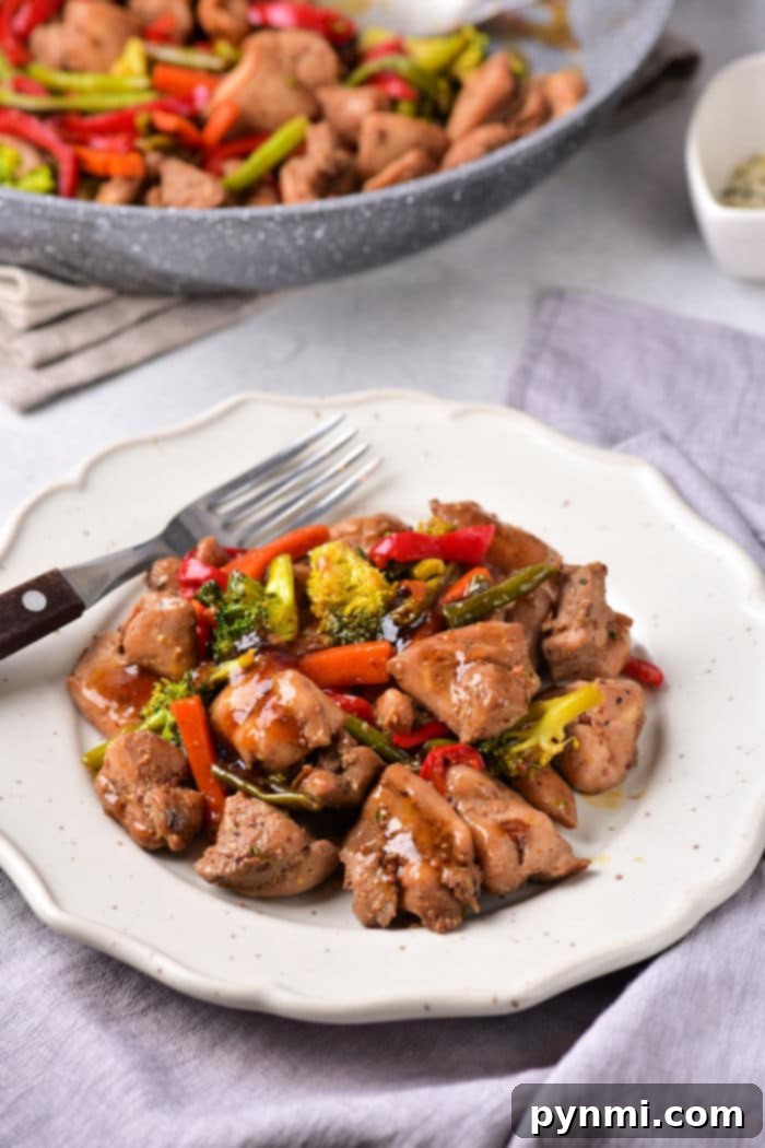 Chinese chicken thigh stir fry with vibrant vegetables and sauce