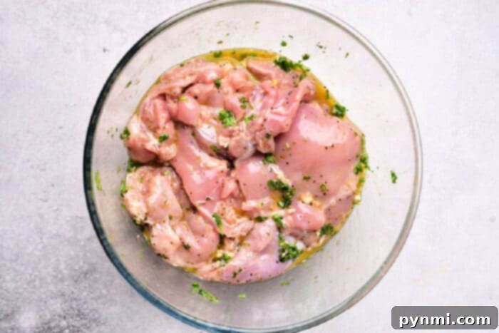 Vibrant Mediterranean Chicken Marinade 5 Succulent, cooked Mediterranean chicken thighs, garnished with fresh herbs, presented on a platter.