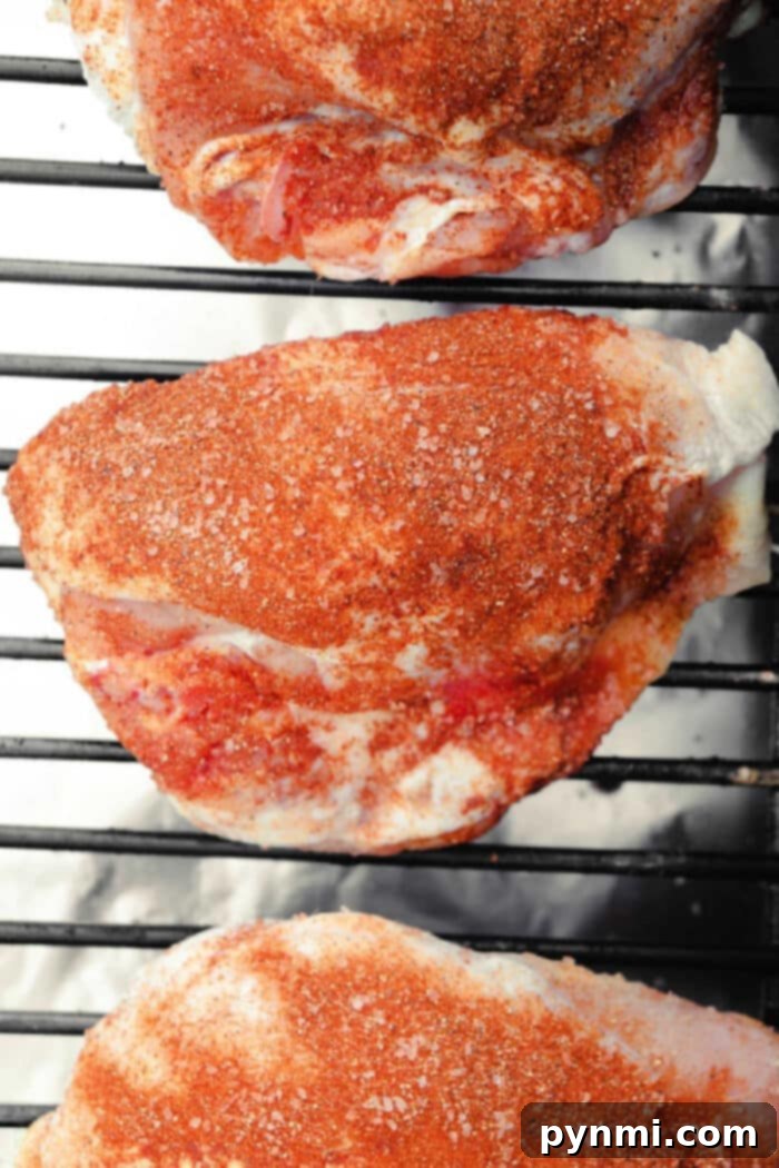 Multiple Traeger Smoked Chicken Breasts resting on a cutting board, perfectly cooked and ready to serve.