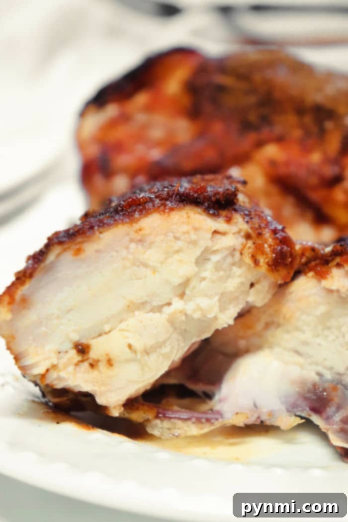 Perfectly cooked and sliced Traeger Smoked Chicken Breasts, showcasing the juicy interior.