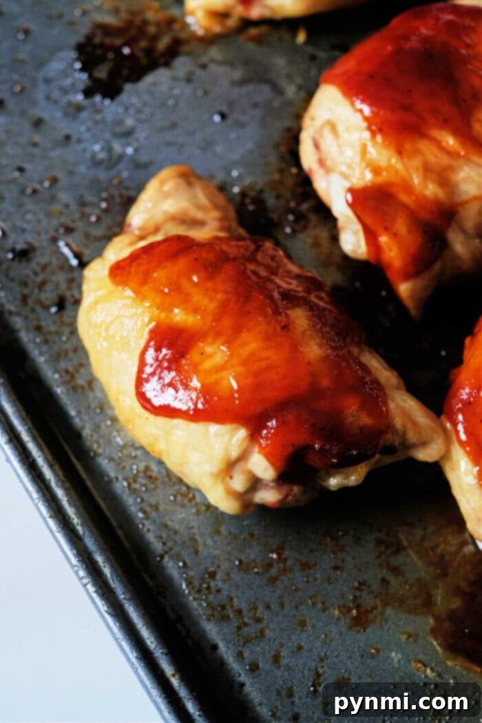 Perfectly Glazed Oven Baked BBQ Chicken Thighs 4 BBQ Baked Chicken Thighs in Oven - close-up of tender chicken ready to serve