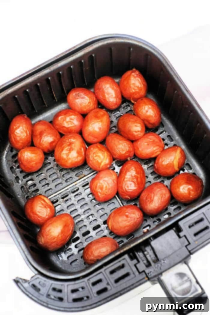 Freshly cooked baby red potatoes, nestled in a black air fryer basket, offer a delightful twist on your favorite baby potatoes recipe.