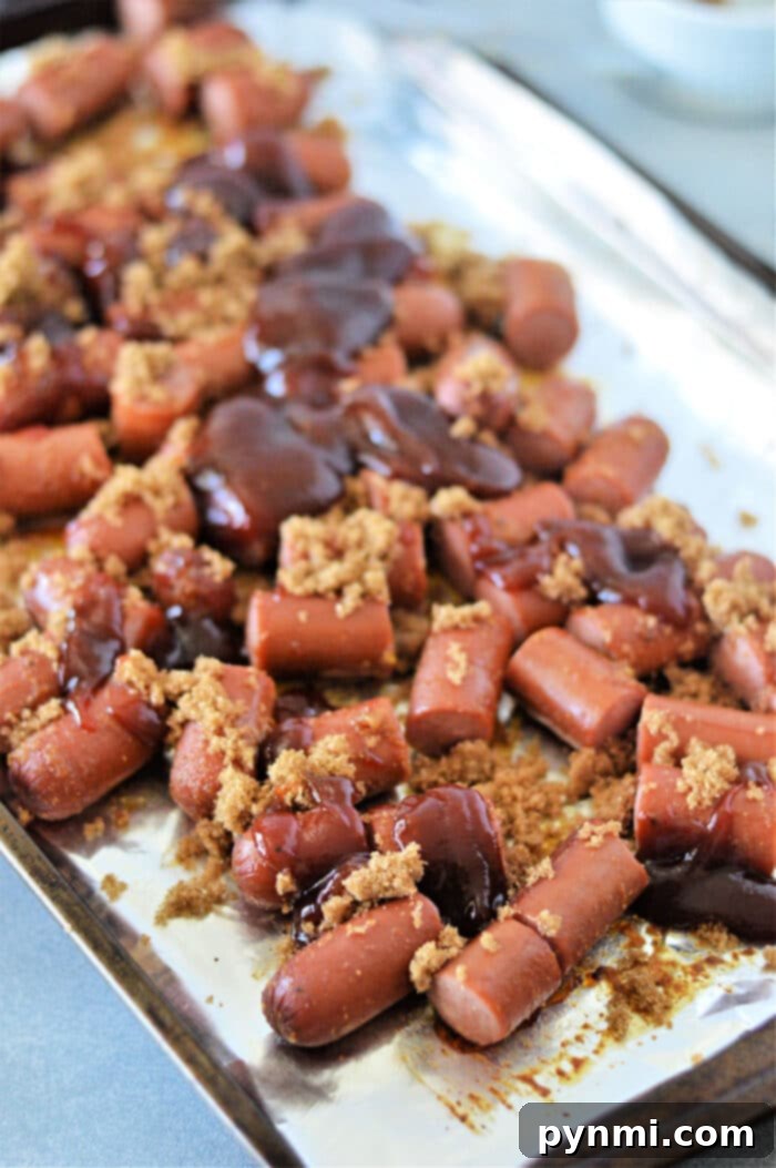 Savor the irresistible taste of Hot Dog Burnt Ends, crafted from chopped hot dogs glazed with brown sugar and barbecue sauce, all roasted to perfection on a baking sheet.