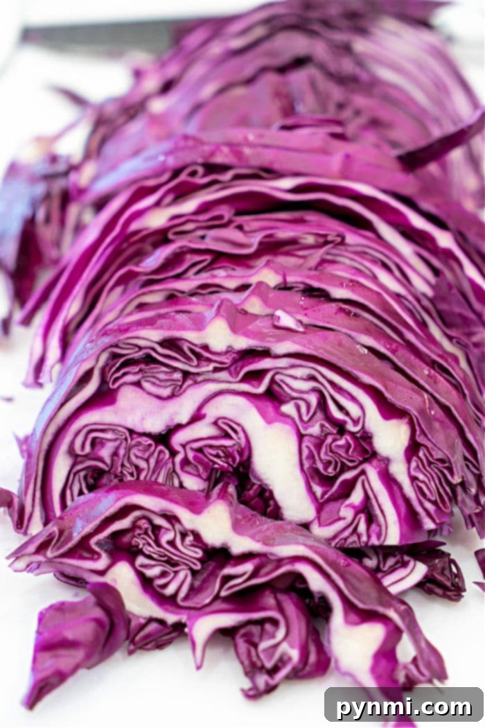 Close-up view of a Dutch oven with melting butter and minced garlic, preparing for the red cabbage to be added.