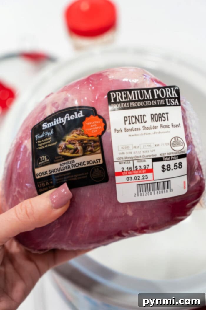 Mastering the Perfect Pork Picnic Roast 3 A hand holds a packaged Pork Picnic Roast, its label clearly displaying the price and weight.