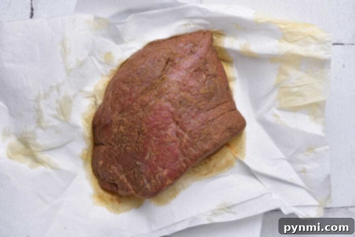 Sliced London Broil roast, showcasing a perfect medium-rare doneness