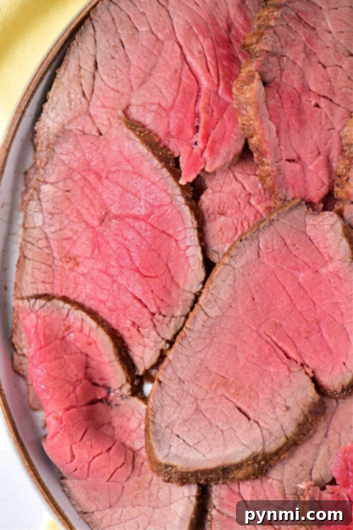London Broil sliced and arranged on a plate with a side dish, ready to be enjoyed