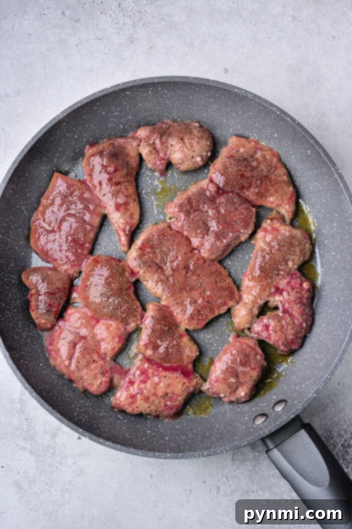 Mastering Deer Liver Cooking 4 Close-up of How to Cook Deer Liver with Onions and Bacon in a Skillet