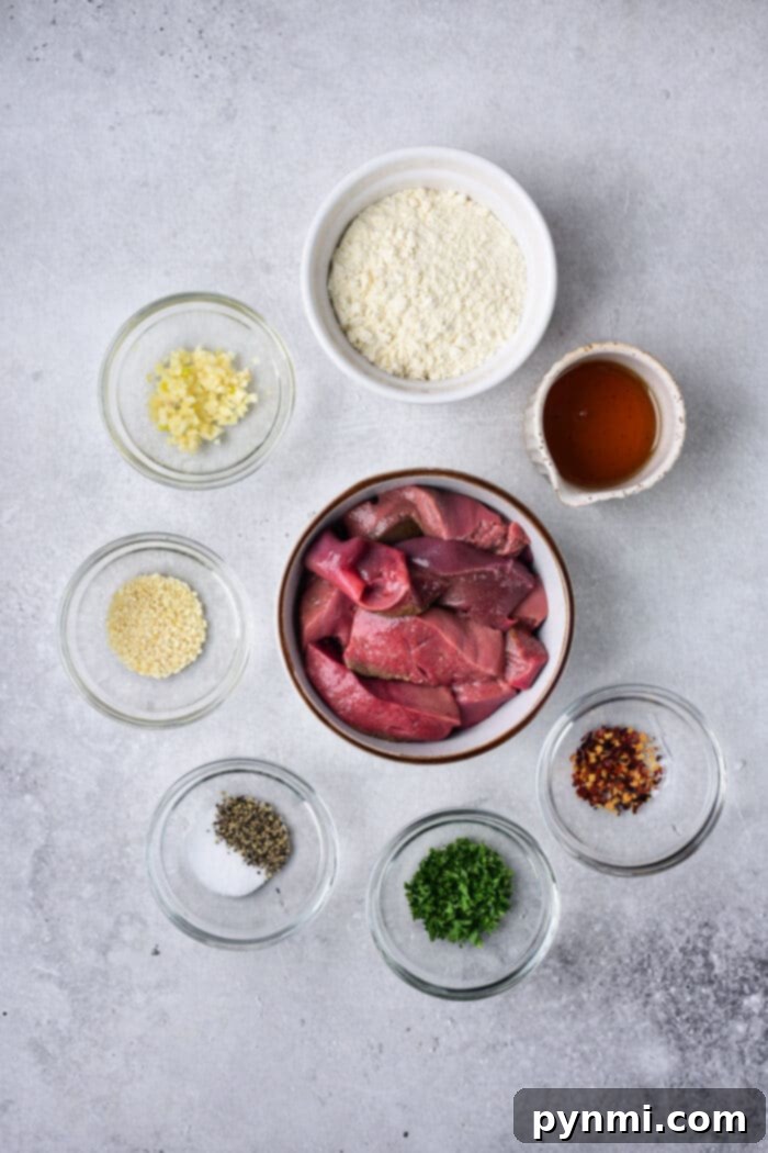Two plates of beautifully cooked pork liver, garnished with fresh herbs, ready to be served