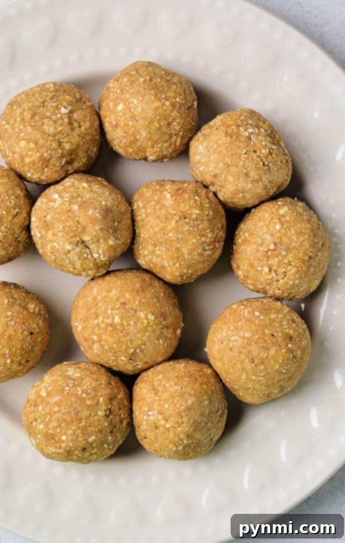 The Matzo Ball Demystified: History, How-To, and a Classic Recipe 2 A cream-colored plate displaying round homemade matzo balls, ready to be served.
