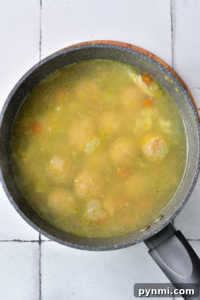The Matzo Ball Demystified: History, How-To, and a Classic Recipe 6 A bowl of rich, clear matzo ball broth, glistening invitingly.