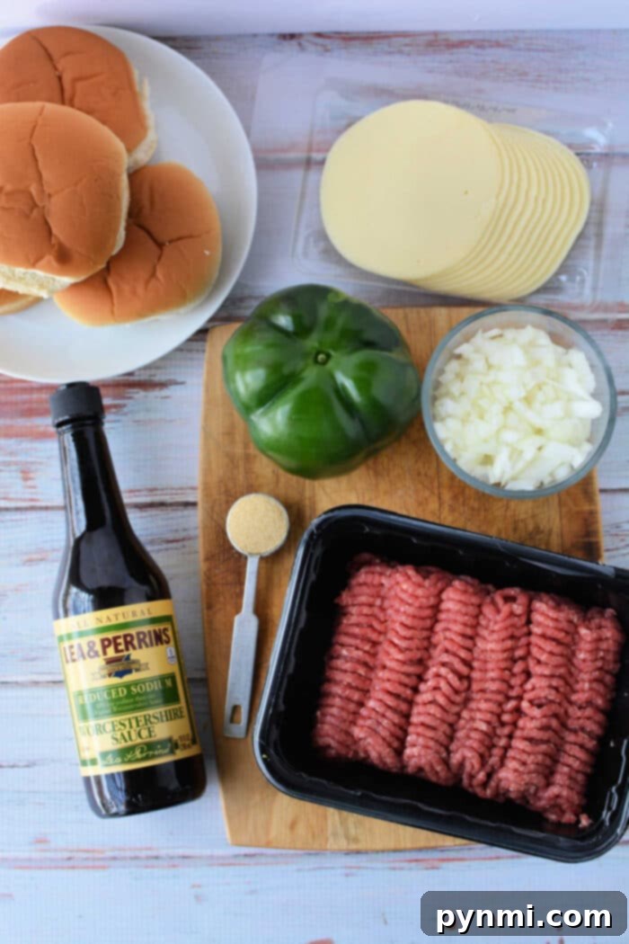 Philly Cheesesteak Sloppy Joes 3 Ingredients for Philly Cheesesteak Sloppy Joes, including ground beef, bell peppers, onions, and provolone cheese slices.