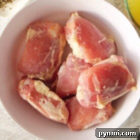 Frozen Chicken: When to Toss or Thaw 8 A bowl with frozen raw chicken thighs rests on a light-colored surface. Remember, knowing how long frozen chicken is good for ensures safety and flavor.