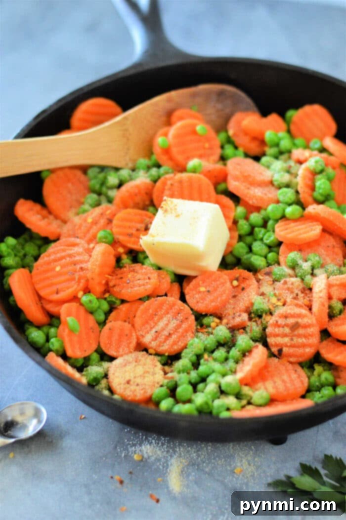 A mix of vibrant frozen peas and carrots, ready to be cooked