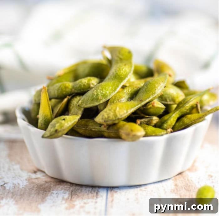 A bowl of freshly cooked and seasoned frozen edamame pods, ready to be enjoyed.