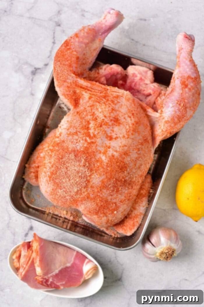 Gourmet Bacon-Wrapped Stuffed Chicken 3 Whole Stuffed Chicken baking in the oven, wrapped in bacon