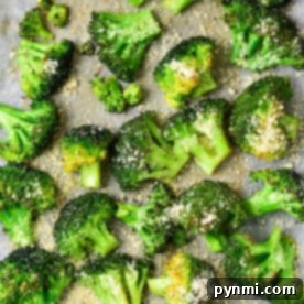 Roasted broccoli florets with grated cheese, nestled on parchment paper, bake frozen to crispy perfection.