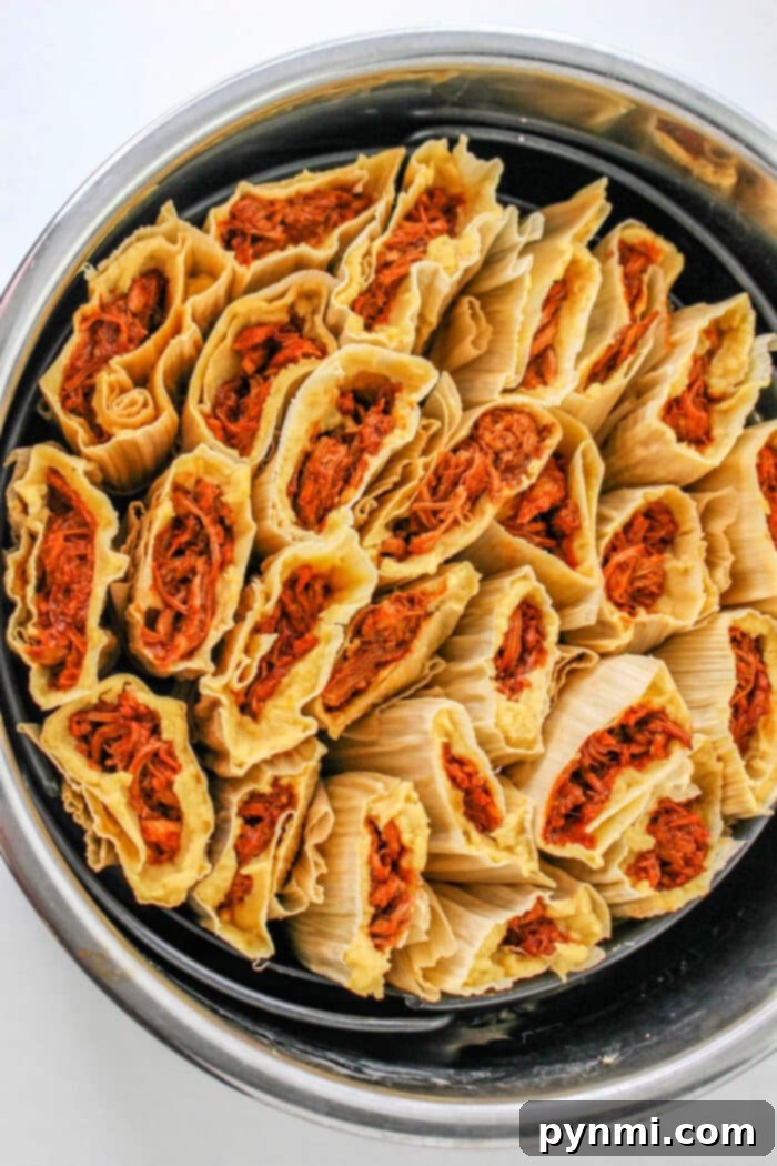 Crafting Authentic Red Tamales From Scratch 2 Delicious homemade red tamales steaming in a pot, ready to be served.