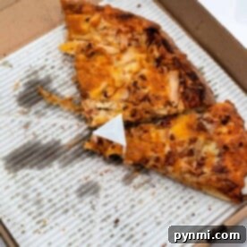 Crispy Pizza Revival: Toaster Oven Method 6 Open pizza box with two slices of baked pizza on a greasy cardboard base, perfect for a quick reheat in the toaster oven.
