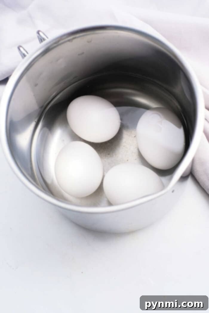 Perfect Soft Boiled Eggs Timing Guide 3 Soft Boiled Eggs from Boiling Water - Two perfectly peeled soft-boiled eggs with runny yolks on a plate.