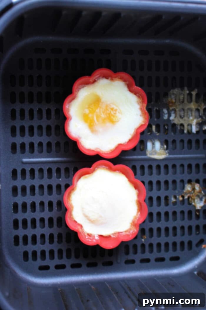 Perfect Soft Boiled Eggs Timing Guide 6 How to Cook Egg soft boiled - A close-up of a soft-boiled egg in a ceramic holder, ready to be eaten.