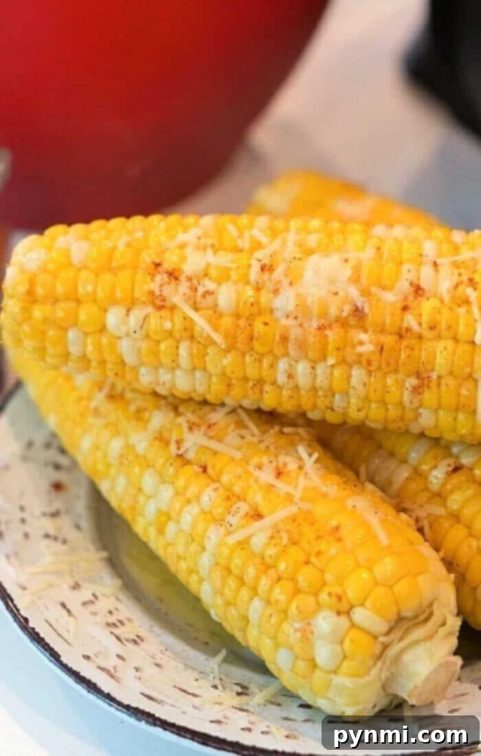 Microwave Corn on the Cob Perfect Timing 2 How Long to Cook Corn on Cob in Microwave - Fresh corn on the cob in its husk, ready for microwaving.