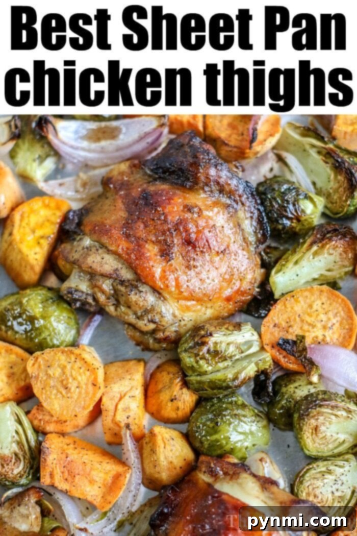 Succulent baked chicken thighs in the oven, surrounded by roasted vegetables.