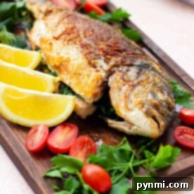 A beautifully pan-fried whole fish, seasoned and ready to serve.