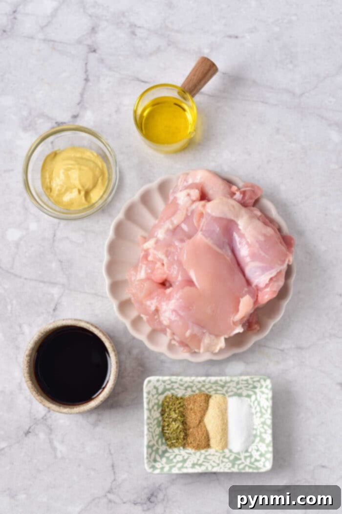 How to Grill Frozen Chicken Thighs - showing thawed, marinated chicken thighs on a plate before grilling.
