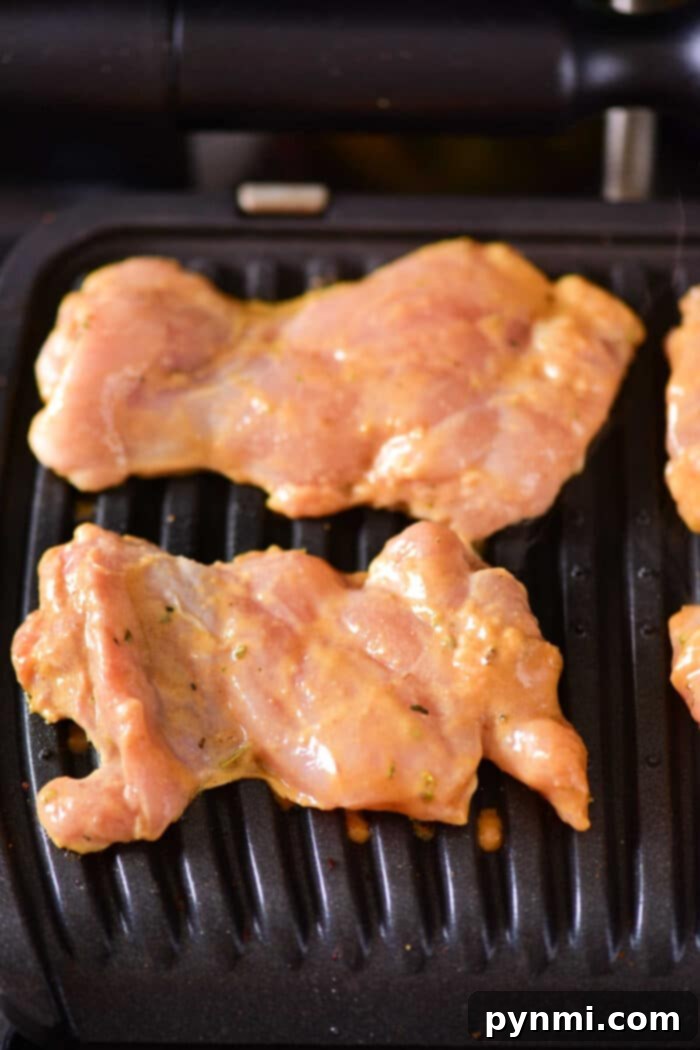 How Long to Grill Boneless Chicken Thighs - showing perfectly grilled boneless chicken thighs on the grill.