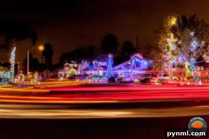 A festive neighborhood in Temecula at night is illuminated with colorful Christmas lights, displaying various decorations. Light trails from passing vehicles create streaks across the foreground, adding dynamic movement to the scene, like a lively map of holiday cheer.