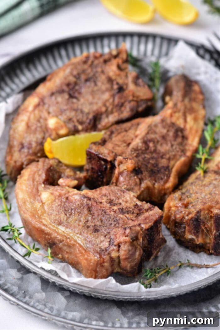 Oven Baked Lamb Chops Slow Cooked Lamb Chops in Oven - Finished lamb chops plated with herbs