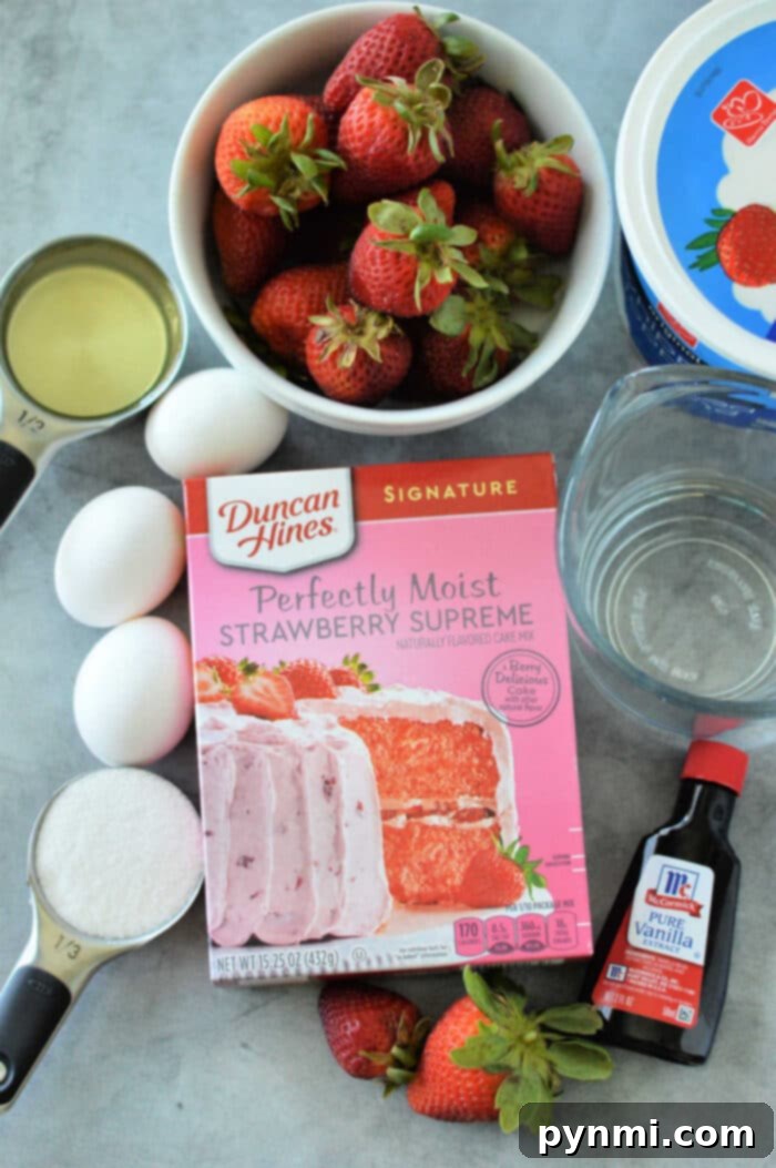 Strawberry cake mix recipe with fresh strawberries, showcasing a baked cake before the poke and fill steps in a 9x13 inch pan.