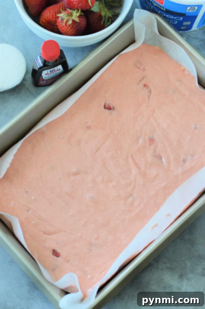 Close-up of a single slice of strawberry poke cake on a white plate, showcasing its moist texture and vibrant berry flavors, ready to be enjoyed.