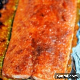 Close-up of a seasoned, baked Coho Salmon fillet on foil, showcasing a golden-brown crust in this delightful recipe.